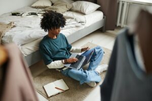 African American Teenager Studying on Floor