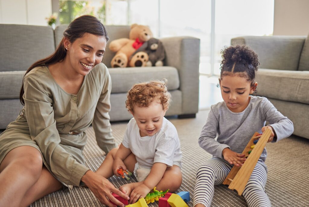 Family, mother and children playing with toys for development, education and childcare creative lea