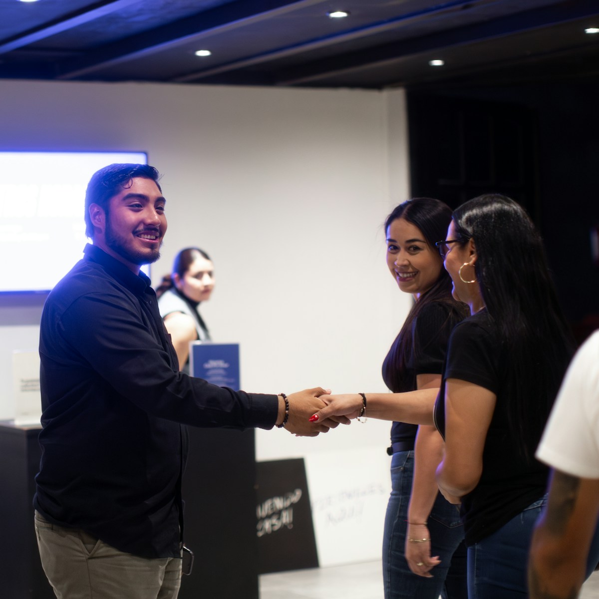 A group of people shaking hands in a room