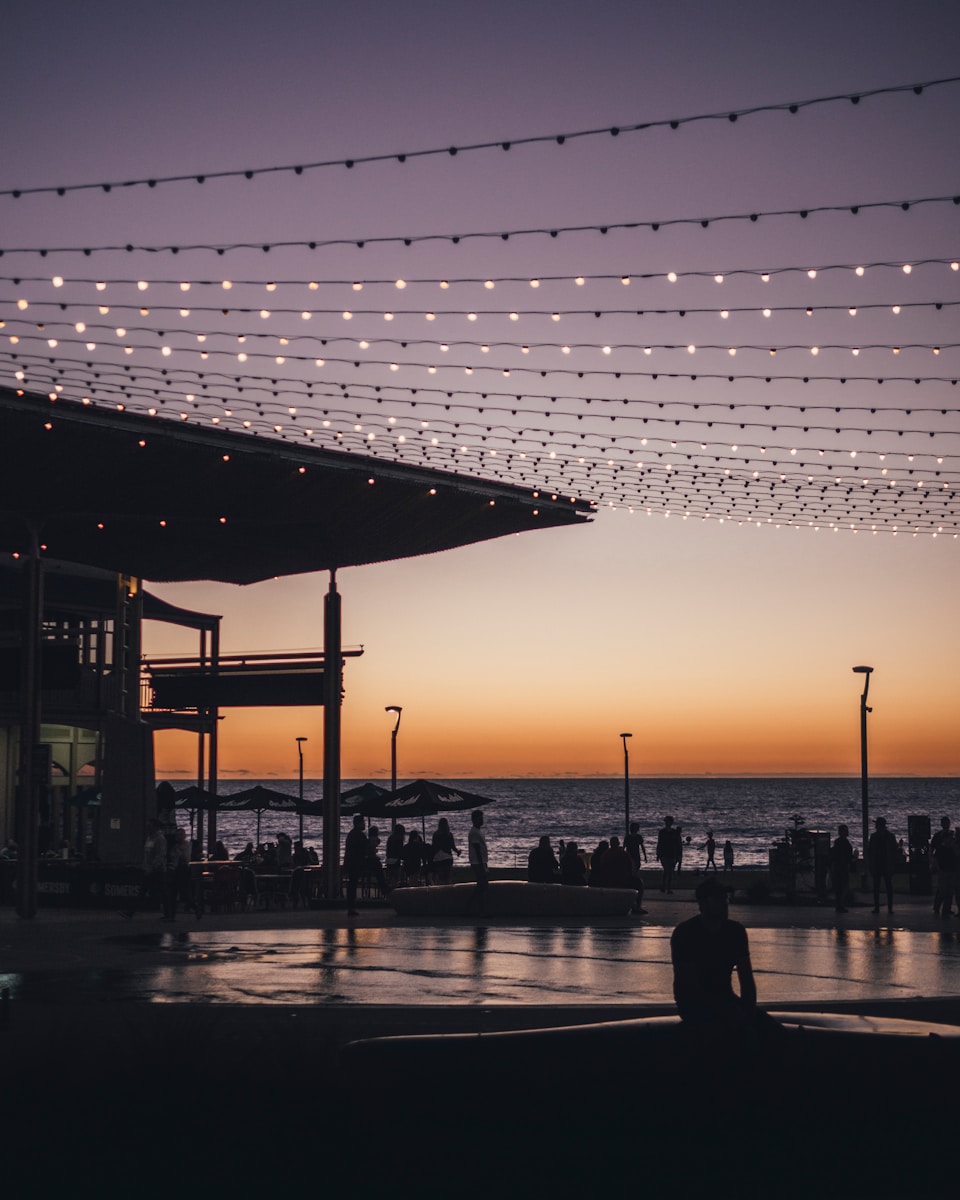 silhouette of man sitting on edge