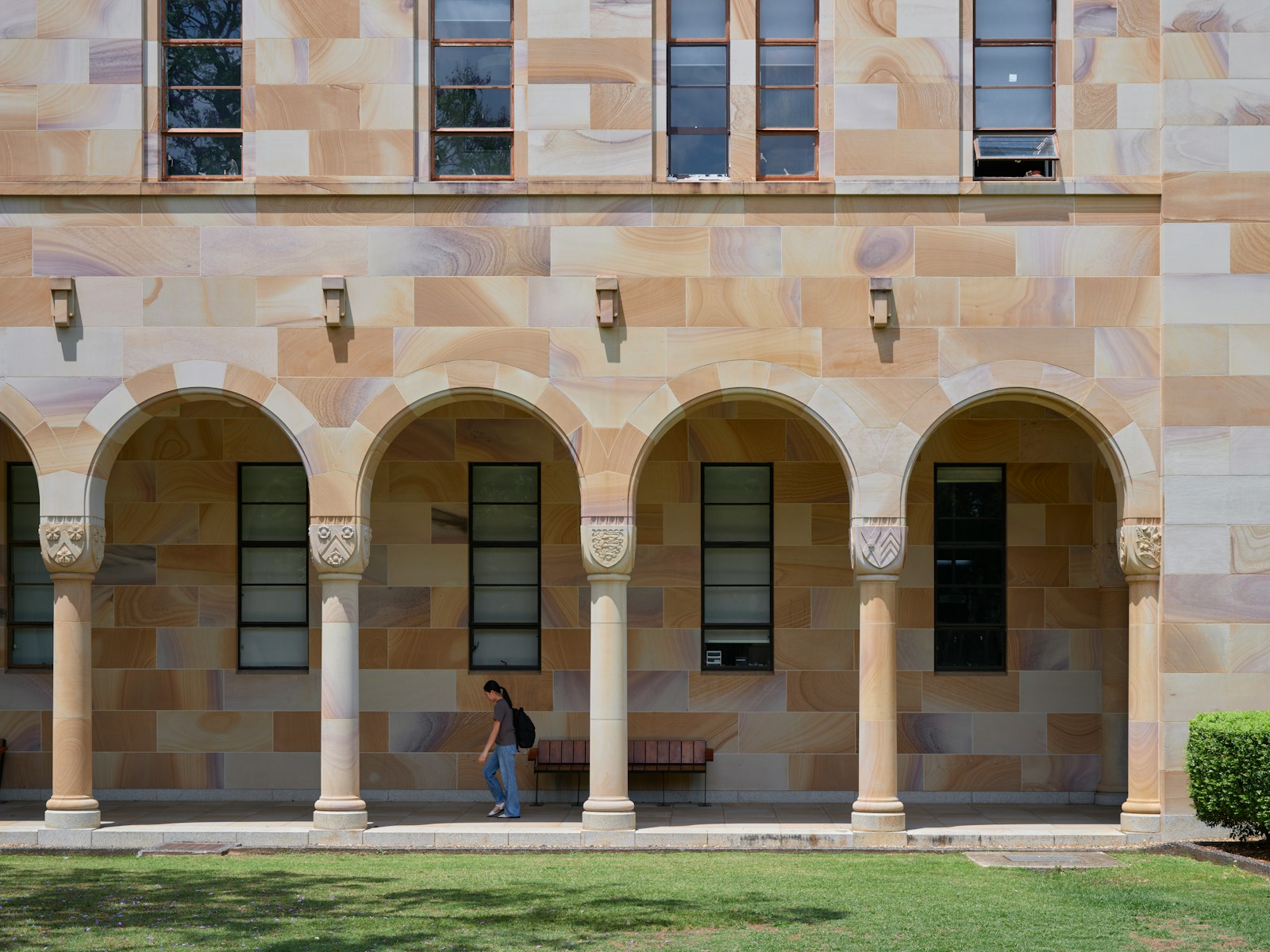 A man walking in front of an old building
