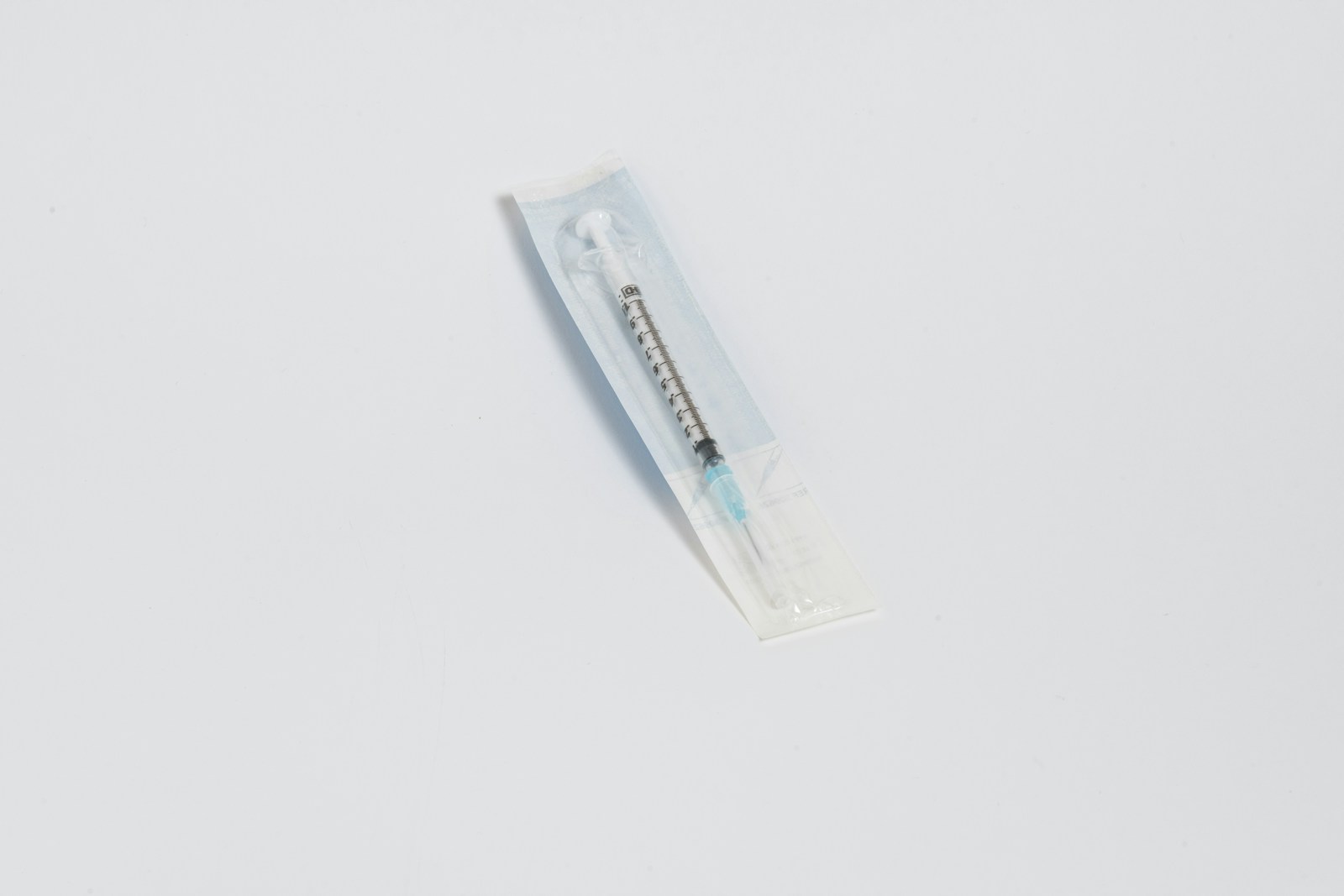 a toothbrush in a package on a white surface